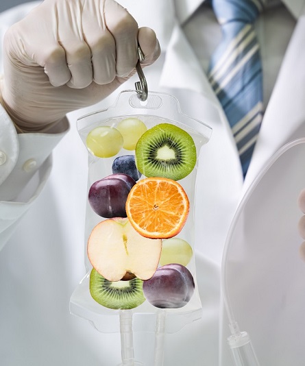 Male,Doctor,Holding,Saline,Bag,With,Fruit,Slices,Inside,In